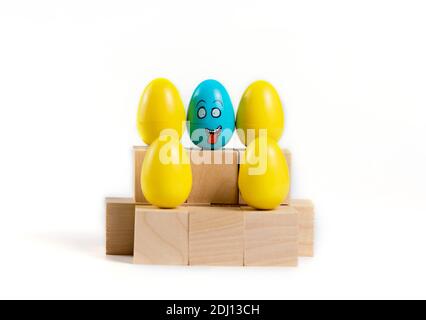 Colorful Plastic Easter Eggs on wooden cubes on white background. Stock Photo