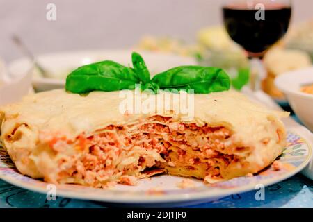 Lasagna Bolognese - classic Italian dish of festive menu for holidays Thanksgiving or Christmas. Cooked traditional recipe lasagna pie cut layers serv Stock Photo