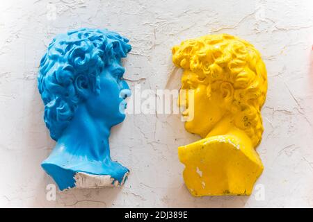 Two statues of david with colors of yellow and blue on the wall in Dafen Oil Painting village, Shenzhen, China. Stock Photo