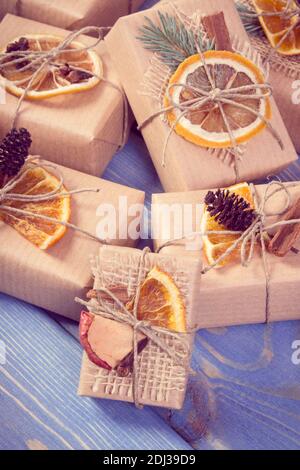 Vintage photo, Wrapped gifts with string and decoration for Christmas or other celebration lying on boards Stock Photo
