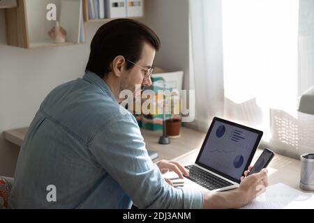 Close up serious businessman wearing glasses working with project statistics Stock Photo