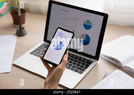 Close up businesswoman holding working with project statistics on devices Stock Photo