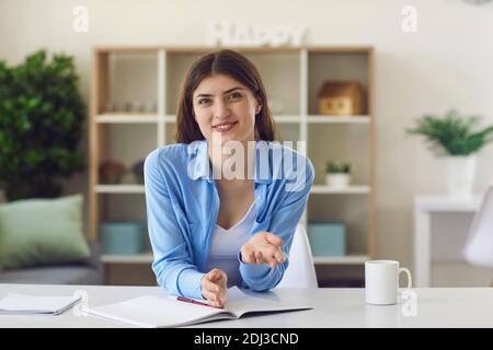 Smiling woman explaining project for colleague Stock Photo