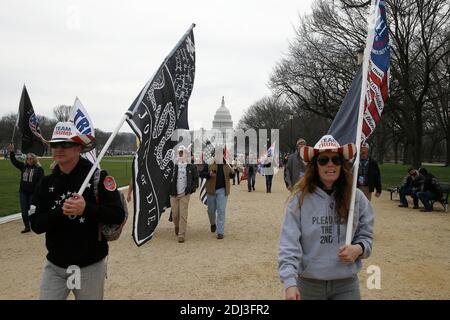Washington, United States. 12th Dec, 2020. President Trump's supporters march with flags along the National Mall during the demonstration.Backers continue to support the President's unproven claims of massive voter fraud and electoral irregularities. Following the November MAGA rally in Washington, Women for America First, a conservative organization, has filed for another permit to rally in support of President Trump, just two days before the electors form each state are to vote for their candidate. Credit: SOPA Images Limited/Alamy Live News Stock Photo