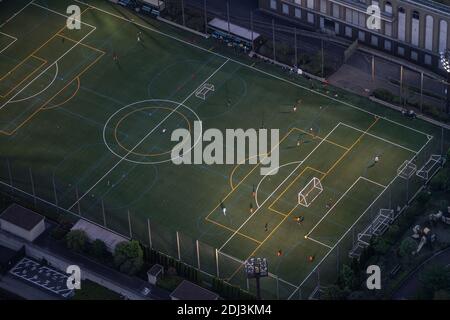 High angle view of kids playing soccer aka football in Tokyo, Japan Stock Photo