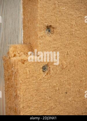 Installation of wooden fibreboard and isolation wool. Warming of floor or wall from outside and its part of windproof and waterproofing system in coun Stock Photo