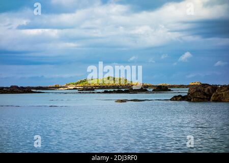 Small rocky islands on the horizon in the archipelago of Iles de Chausey. Brittany in France. Stock Photo