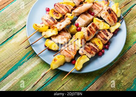 Barbecue turkey shish kebab with apple on rural wooden table Stock Photo