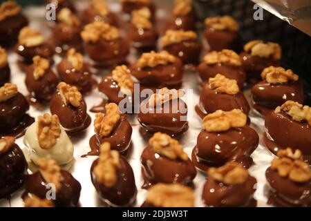 Close up of tray in german kitchen with group fresh homemade shiny fig walnut marzipan pralines Stock Photo
