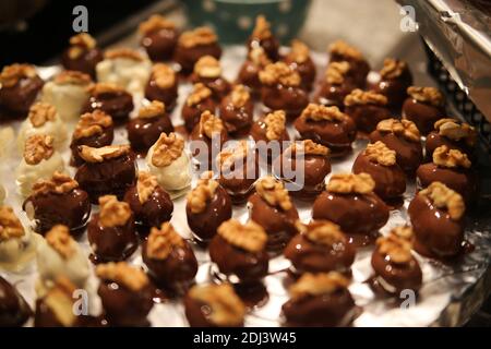 Close up of tray in german kitchen with group fresh homemade shiny fig walnut marzipan pralines Stock Photo