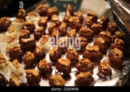 Close up of tray in german kitchen with group fresh homemade shiny fig walnut marzipan pralines Stock Photo