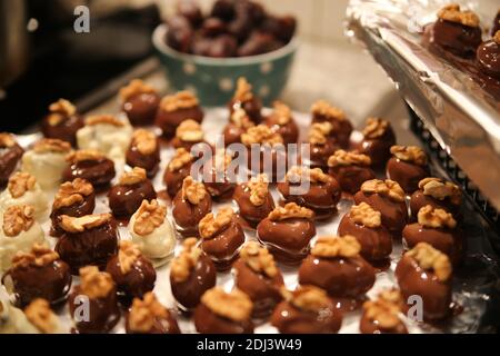 Close up of tray in german kitchen with group fresh homemade shiny fig walnut marzipan pralines Stock Photo