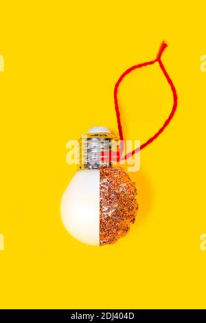 Reuse concept. New year or Christmas DIY decoration made from LED lamps and glitter Stock Photo