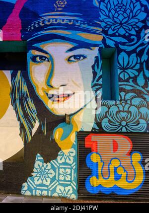 Detail of  graffiti street art by artist Shepard Fairey on the exterior of a building at Whitby Street Shoreditch London, UK Stock Photo