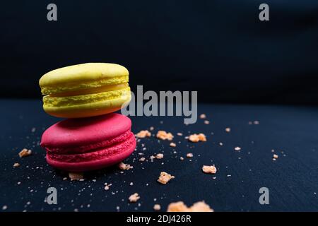 Colourful stack of macaroons isolated on plain black background. Copyspace Stock Photo