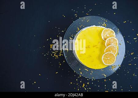 Black background, Lemon cheese cake on a glass plate.(copyspace) Stock Photo