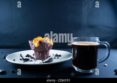 Chocolate muffin, coffee and chocolate chips Stock Photo