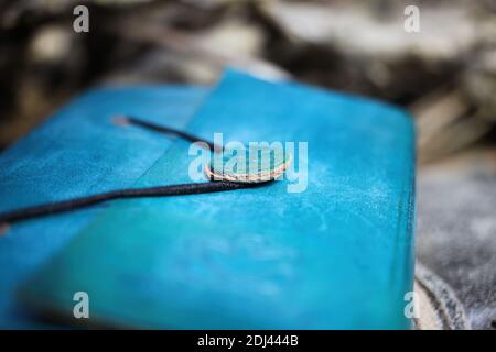 Macro close up of simple lock of blue diary book with vintage leather binding (selective focus on front of button) Stock Photo