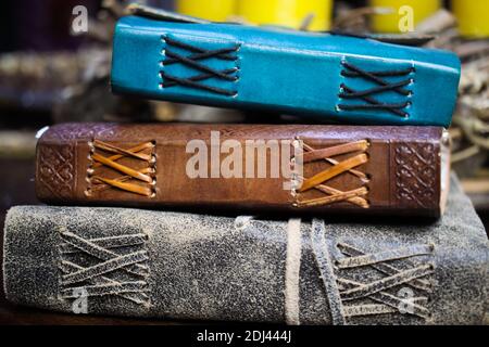 Close up of stack isolated blank spine of three old blue and brown books with vintage leather binding Stock Photo