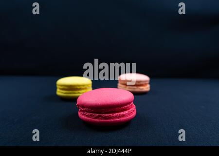 Colourful stack of macaroons isolated on plain black background, Copyspace Stock Photo