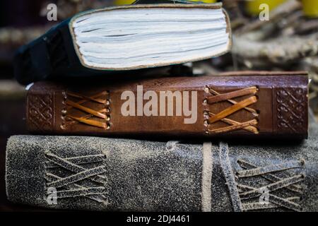 Close up of stack isolated blank spine of three old brown books with vintage leather binding Stock Photo
