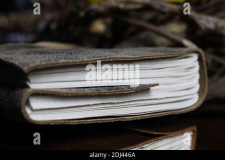 Close up of pages of isolated book top  with vintage leather binding Stock Photo