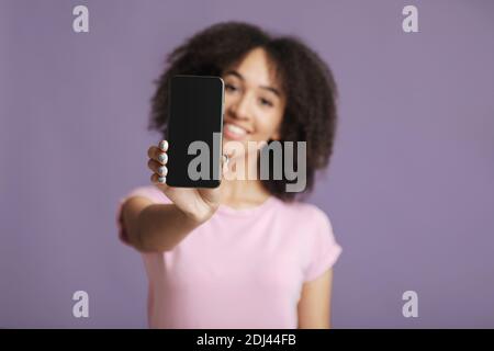 Positive expression. Cheerful female in pink t-shirt with curly hair Stock Photo