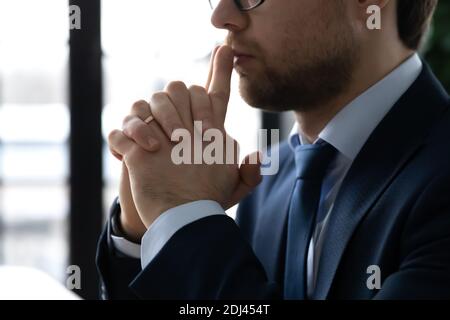 Close up side view thoughtful businessman pondering project strategy Stock Photo