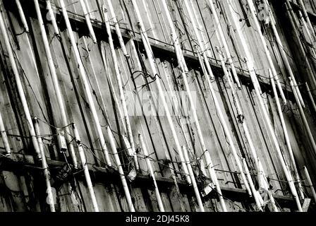 Burnt neon lamps on a broken advertising board in black and white. Stock Photo