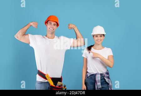 DIY Renovation. Woman Pointing At Strong Boyfriend While They Doing Repair Together Stock Photo