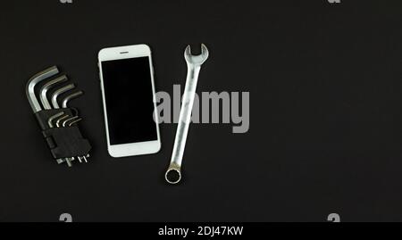 A set of tools for repairing a smartphone or tablet or cell phone. Modern smartphone, copy space. Close-up, white background, isolate. Stock Photo