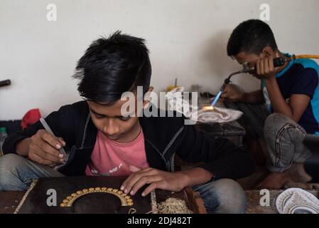 Dhaka, Bangladesh. 12th Dec, 2020. Workers making and sorting out copper and silver jewelry during Covid-19 outbreak at Bhakurta village in Savar on the outskirts of the capital. In total, there are 500 shops and households involved in the trade, providing livelihood to at least 2,500 families in Bhakurta and neighbouring villages. (Photo by Fatima Tuj Johora/Pacific Press) Credit: Pacific Press Media Production Corp./Alamy Live News Stock Photo