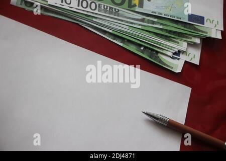 100 euro bills, pen and blank paper with copyspace. Money, profitable business and management education concept. Stock Photo