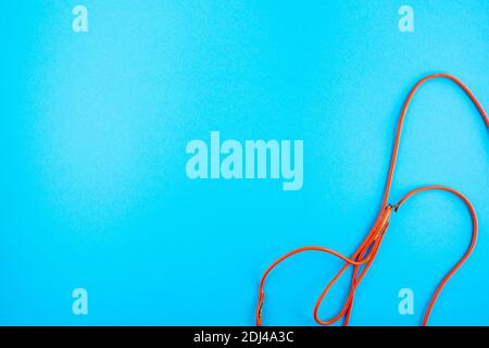 burnt electrical wire on blue background. Copy space Stock Photo
