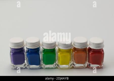 Six glass jars with paint with the colors diversity Stock Photo