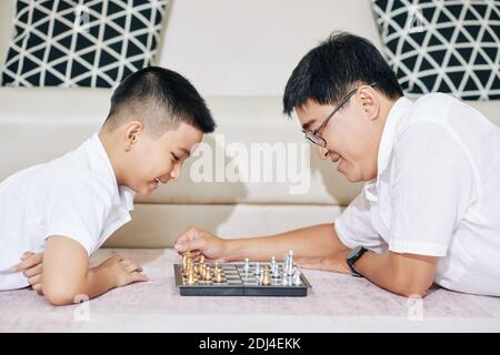 Father and son playing chess Stock Photo