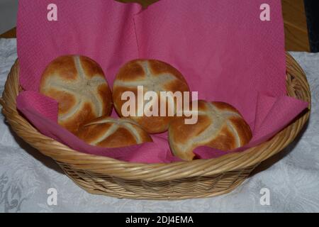 fresh baked wheat bread rolls in wicker basket ready-to-eat Stock Photo
