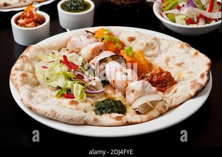 Indian Ethnical Food Chicken tikka masala on Naan Bread Stock Photo