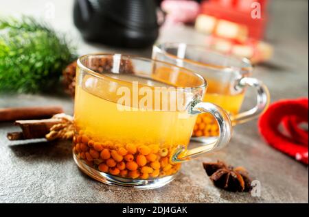 Tea with sea buckthorn berries in glass Stock Photo