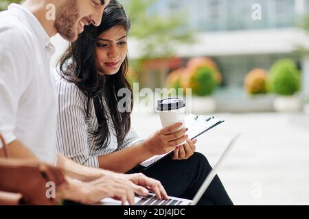 Business people having meeting outdoors Stock Photo