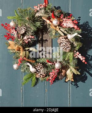 Christmas wreath decoration hanging on front door of house, UK Stock Photo