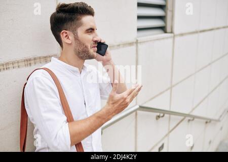 Bearded man talking on phone Stock Photo