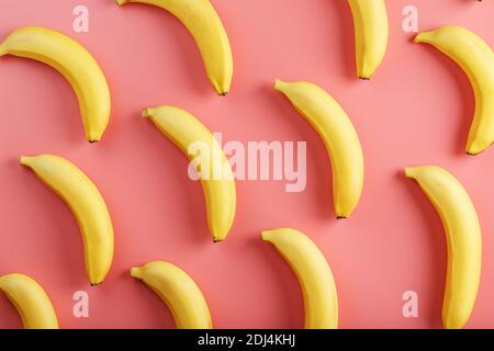 Bright pattern of yellow bananas on a pink background. View from above. Flat lay. Fruit patterns Stock Photo