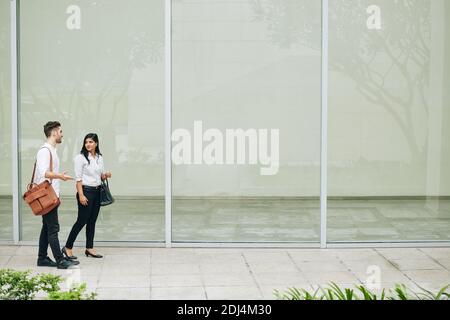 Young business people walking down the street and discussing new projects and ideas Stock Photo