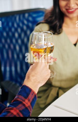 Close-up image of business colleagues clinking champagne glasses over office table Stock Photo