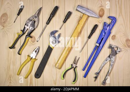 A set of assorted work carpentry and locksmith tools on a light wooden background with copy space. Stock Photo