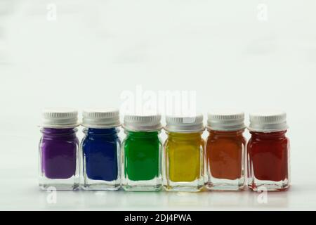 Six glass jars with paint with the colors diversity Stock Photo