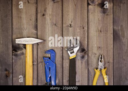 Set of assorted work carpentry and locksmith tools on a dark wooden background with copy space. Stock Photo