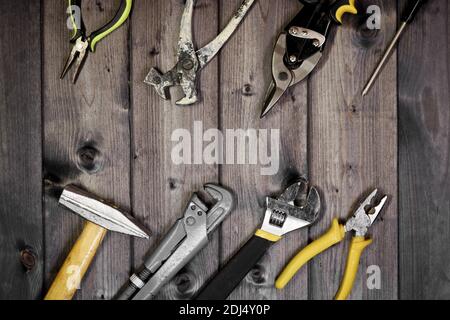 Set of assorted work carpentry and locksmith tools on a dark wooden background with copy space. Stock Photo