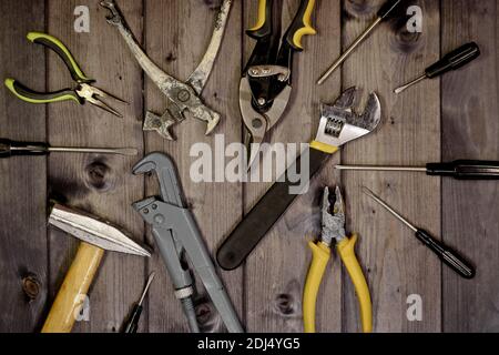 Set of assorted work carpentry and locksmith tools on a dark wooden background with copy space. Stock Photo